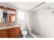 Bathroom with a single sink vanity, toilet and tiled walk-in shower at 8430 Pamlico St, Orlando, FL 32817