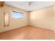 Bedroom with wood floor, large window, and a light-colored wall with floral accents at 8430 Pamlico St, Orlando, FL 32817