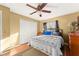 Bedroom featuring hardwood floor, bed, side table, large closet, and natural light from windows at 8430 Pamlico St, Orlando, FL 32817