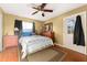 Bedroom featuring hardwood floor, area rug, bed, dresser, and natural light from windows at 8430 Pamlico St, Orlando, FL 32817