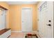 Inviting entryway featuring tiled flooring and a convenient hall tree with coat hooks and bench seating at 8430 Pamlico St, Orlando, FL 32817