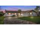 Single-story home featuring a two-car garage and curved driveway at 8430 Pamlico St, Orlando, FL 32817