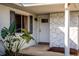 Inviting front entrance featuring stone accents, a decorative window, and lush landscaping at 8430 Pamlico St, Orlando, FL 32817