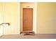 Front door of unit 208 with yellow wall at 8775 Sartori St # 208, Orlando, FL 32829