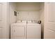 A white washer and dryer set are found inside the laundry area at 8775 Sartori St # 208, Orlando, FL 32829