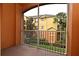 Screened patio with a view of the community buildings and landscaping at 8775 Sartori St # 208, Orlando, FL 32829