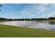 Community pond with a fountain and lush landscaping under a blue sky at 8775 Sartori St # 208, Orlando, FL 32829