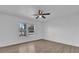 Bedroom featuring new flooring, a window, and a ceiling fan at 901 S Holly Ave, Sanford, FL 32771