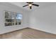 Bright bedroom with large window, ceiling fan, and new flooring at 901 S Holly Ave, Sanford, FL 32771