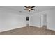 Bedroom featuring new flooring, ceiling fan, and access to the bathroom at 901 S Holly Ave, Sanford, FL 32771