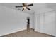 Bedroom featuring new flooring, ceiling fan, and a closet for optimal storage at 901 S Holly Ave, Sanford, FL 32771