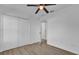 Bright bedroom featuring new flooring, ceiling fan, and a closet at 901 S Holly Ave, Sanford, FL 32771