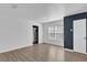 Bright bedroom with wood-look floors, fresh paint, and ample natural light from the window at 901 S Holly Ave, Sanford, FL 32771