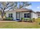 Inviting single-story home with a cozy, screened-in porch and neat front yard at 901 S Holly Ave, Sanford, FL 32771