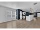 Open floor plan with new flooring flows from the living area into the kitchen featuring modern pendant lighting at 901 S Holly Ave, Sanford, FL 32771