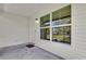 Covered porch featuring a bright white exterior, large windows, and concrete flooring at 901 S Holly Ave, Sanford, FL 32771