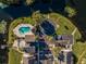 Aerial view of the property showing a pool, parking, nearby lake, and surrounding landscape at 942 Lake Destiny Rd # B, Altamonte Springs, FL 32714