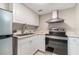 Cozy kitchen featuring stainless steel appliances, white cabinets, and a stainless-steel sink at 942 Lake Destiny Rd # B, Altamonte Springs, FL 32714