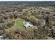 A home surrounded by trees, with a green lawn and a pool at 10688 Sw 129Th Terrace Rd, Dunnellon, FL 34432