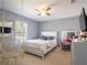 Cozy bedroom featuring a unique hanging chair, plush carpet, and ample natural light at 10688 Sw 129Th Terrace Rd, Dunnellon, FL 34432