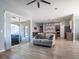 Open-concept living room featuring modern finishes, wood-look flooring, and an easy transition into the kitchen at 10688 Sw 129Th Terrace Rd, Dunnellon, FL 34432