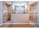 Luxurious main bathroom featuring dual walk-in showers with decorative tile work at 10688 Sw 129Th Terrace Rd, Dunnellon, FL 34432