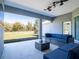 This covered patio features modern outdoor seating and a view of the backyard at 10688 Sw 129Th Terrace Rd, Dunnellon, FL 34432