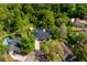 Beautiful aerial view of a landscaped property with mature trees and a private backyard pool at 113 Wheatland Ct, Longwood, FL 32779