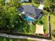 Aerial view of a home with a screened-in pool, spacious yard and mature landscaping at 113 Wheatland Ct, Longwood, FL 32779