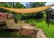 Private backyard featuring a shaded patio area, lounge chairs, and lush greenery, perfect for outdoor relaxation at 113 Wheatland Ct, Longwood, FL 32779