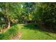 Expansive backyard featuring lush greenery, mature trees and an ideal space for outdoor enjoyment at 113 Wheatland Ct, Longwood, FL 32779