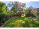 Large, verdant backyard features mature trees, landscaping, and plenty of green space at 113 Wheatland Ct, Longwood, FL 32779