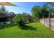 Well-maintained backyard with a lush lawn, wooden fence, and mature landscaping at 113 Wheatland Ct, Longwood, FL 32779