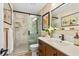 Bathroom with walk-in shower with glass door and vanity with dark wood cabinets at 113 Wheatland Ct, Longwood, FL 32779