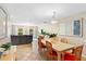 Open-concept dining room with wood table, seating for six, and views into the living room at 113 Wheatland Ct, Longwood, FL 32779