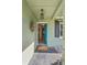 Inviting front porch with a blue door, decorative wreath, and slate flooring at 113 Wheatland Ct, Longwood, FL 32779