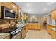 Spacious kitchen featuring stainless steel appliances, ample counter space, and modern lighting at 113 Wheatland Ct, Longwood, FL 32779