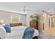 Main bedroom featuring ceiling fan, two dressers, and view to ensuite bathroom at 113 Wheatland Ct, Longwood, FL 32779