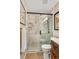 Modern shower featuring marble-look tile, glass enclosure, and bronze hardware at 113 Wheatland Ct, Longwood, FL 32779
