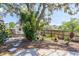 Landscaped backyard featuring lush greenery, a mature tree, and a stepping stone walkway at 116 Cambridge Dr, Longwood, FL 32779