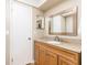 Bathroom featuring wood cabinets, a granite countertop, and a large mirror at 116 Cambridge Dr, Longwood, FL 32779