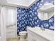 Bathroom featuring blue walls, a toilet, and a shower at 116 Cambridge Dr, Longwood, FL 32779