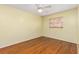 Cozy bedroom features wood-look flooring, a ceiling fan, and a window at 116 Cambridge Dr, Longwood, FL 32779