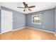 Bedroom with laminate flooring, painted blue walls, and natural light from a window at 116 Cambridge Dr, Longwood, FL 32779