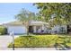 Charming single story home with white brick, an attached garage, front yard, and welcoming rocking chairs on the porch at 116 Cambridge Dr, Longwood, FL 32779