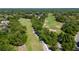 Picturesque aerial view of the golf course featuring mature trees and multiple greens at 116 Cambridge Dr, Longwood, FL 32779