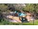 Aerial view of the neighborhood playground equipment surrounded by mature trees at 116 Cambridge Dr, Longwood, FL 32779