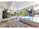 Relaxing sunroom overlooking a refreshing outdoor swimming pool and lush landscaping at 116 Cambridge Dr, Longwood, FL 32779