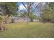 View of backyard, home's rear, and firepit; offers great outdoor space and relaxation potential at 119 Mayfair Cir, Sanford, FL 32771