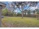 Expansive backyard with mature trees providing ample shade and a lush lawn at 119 Mayfair Cir, Sanford, FL 32771